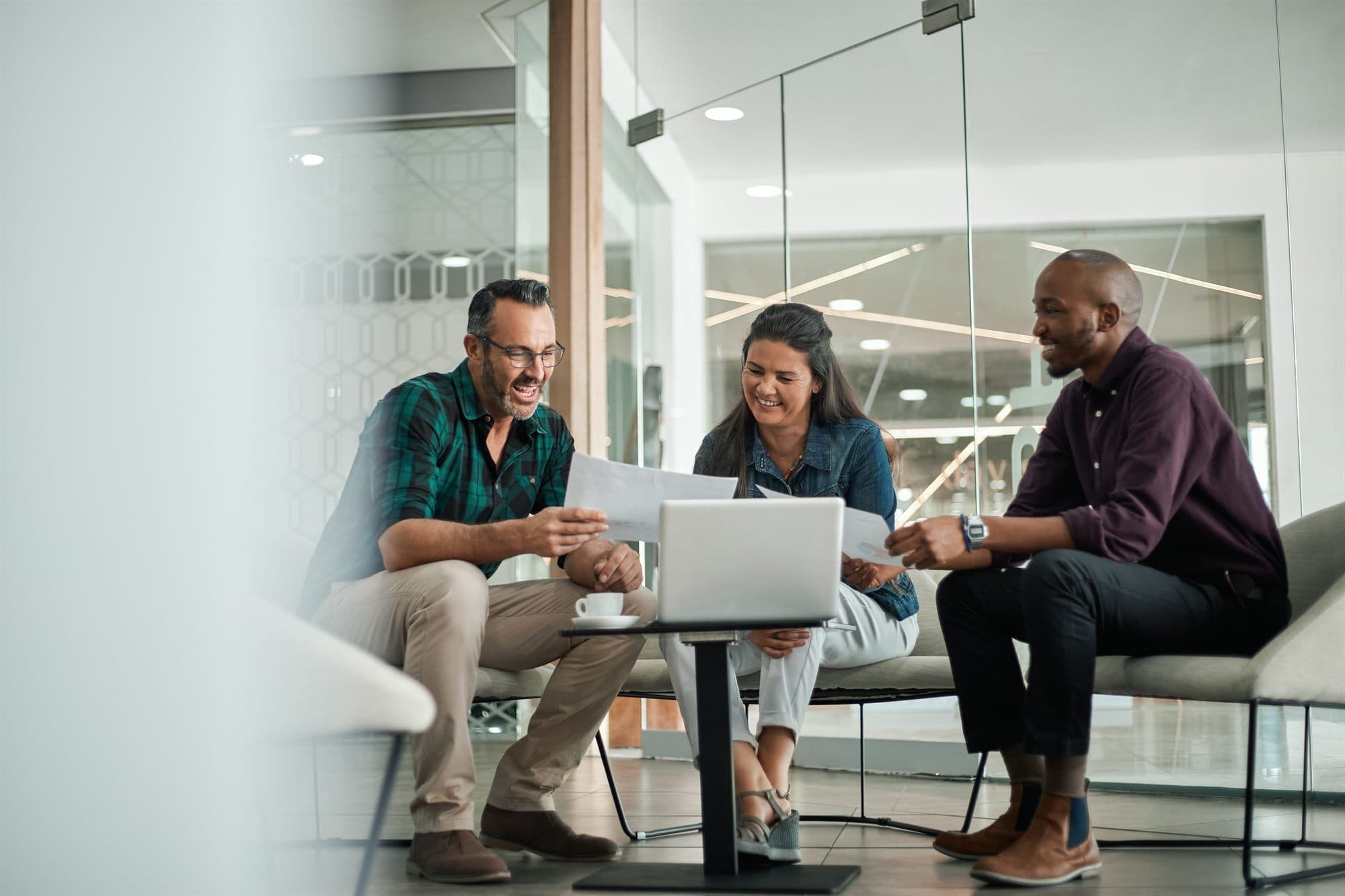 Manufacturer and distributor partners collaborating over documents in a modern office